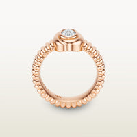 A gold 18k rose gold ring featuring a textured band and bezel-set white diamond. 