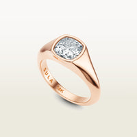 A cushion-cut diamond set in a bold 18k rose gold bezel ring, engraved with “SULA 18K” on the inside of the band.