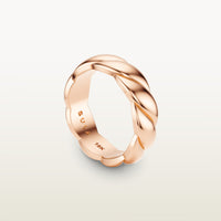 A sculptural 18k rose gold band with a shea-shell, robe-like form and scalloped interior, engraved with “SULA 18K” on the inside.