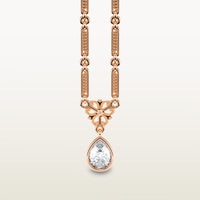 A delicate 18k rose gold necklace  with elongated textured links, an ornate vintage-style bail, and a bezel-set pear-shaped diamond pendant.
