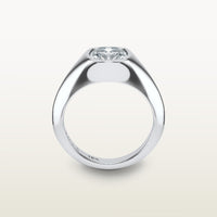 An 18k white gold ring featuring a cushion-cut diamond in a soft bezel setting, with a smooth, tapered band, engraved with “SULA 18K” on the inside
