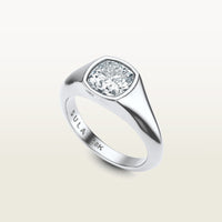 A cushion-cut diamond set in a bold 18k white gold bezel ring, engraved with “SULA 18K” on the inside of the band.