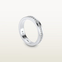 An 18k white gold eternity band featuring round brilliant diamonds in a sleek channel setting, engraved with “SULA 18K” on the inside.