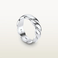 A sculptural 18k white gold band with a shea-shell, robe-like form and scalloped interior, engraved with “SULA 18K” on the inside.
