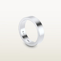 A minimalist 18k white gold band with a flat profile and 90 degree edge, engraved with “SULA 18K” on the inside.