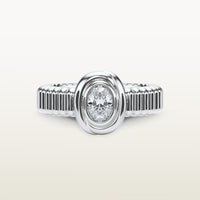 A gold 18k white gold ring featuring a textured band and bezel-set white diamond. 