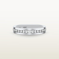 An 18k white gold eternity band featuring round brilliant diamonds in a sleek channel setting, engraved with “18K” on the inside.