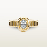 A gold 18k yellow gold ring featuring a textured band and bezel-set white diamond. 